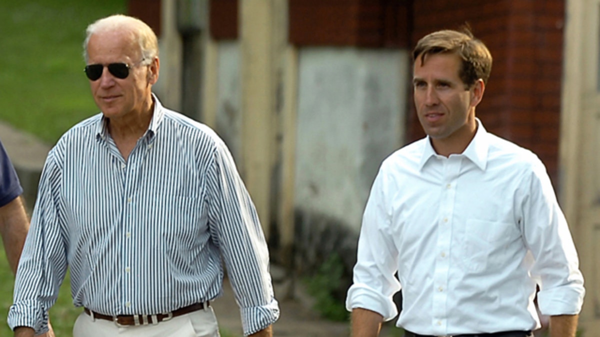 FILE: July 4, 2012: Delaware Attorney General Beau Biden, right, takes a walk with his father,Vice President Joe Biden, to the Green Ridge Little Baseball Field in Scranton, Pa. 