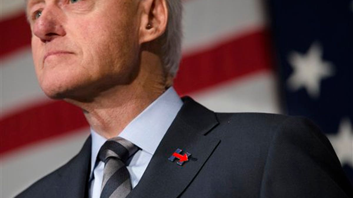 Former President Bill Clinton wears a campaign pin for his wife, Democratic presidential candidate Hillary Clinton, as he campaign for her, Friday, Feb. 12, 2016, at the Clifton Cultural Arts Center in Cincinnati. (AP Photo/John Minchillo)