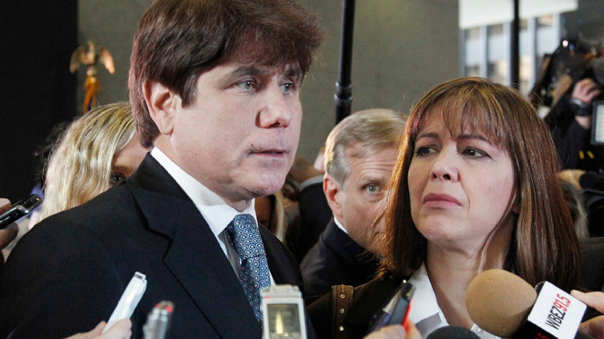 FILE - In this Dec. 7, 2011 file photo, former Illinois Gov. Rod Blagojevich, left, speaks to reporters as his wife, Patti, listens at the federal building in Chicago, after Blagojevich was sentenced to 14 years on 18 corruption counts. On Monday, March 28, 2016, the U.S. Supreme Court rejected Blagojevich's appeal of his corruption convictions that included his attempt to sell the vacant Senate seat once occupied by President Barack Obama. (AP Photo/M. Spencer Green, File)
