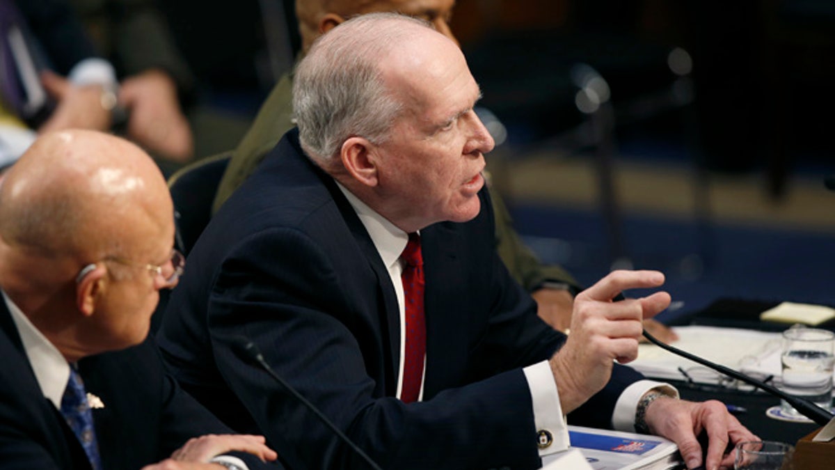 CIA Director John Brennan, flanked by Director of the National Intelligence Director James Clapper, left, and Defense Intelligence Agency Director Lt. Gen. Vincent Stewart, testifies on Capitol Hill in Washington, Tuesday, Feb. 9, 2016, before Senate Intelligence Committee hearing on worldwide threats. (AP Photo/Alex Brandon)