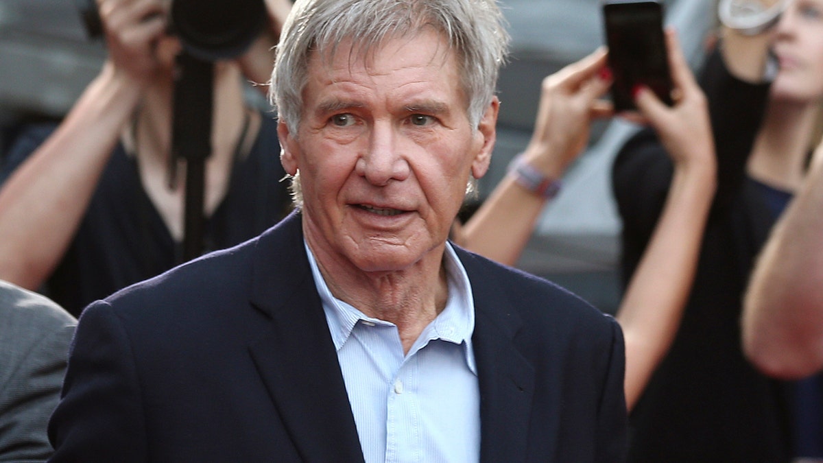 FILE - In this December 10, 2015 file photo, Harrison Ford greets fans during a Star Wars fan event in Sydney. A film production company has been fined 1.6 million pounds ($1.95 million) over an accident on the set of 