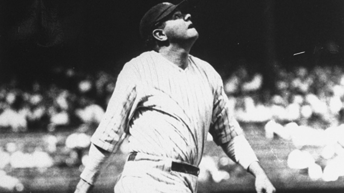 FILE 1927: Babe Ruth lofts another home run into the right field upper deck at Yankee Stadium in New York on the way to his 60-home run year.