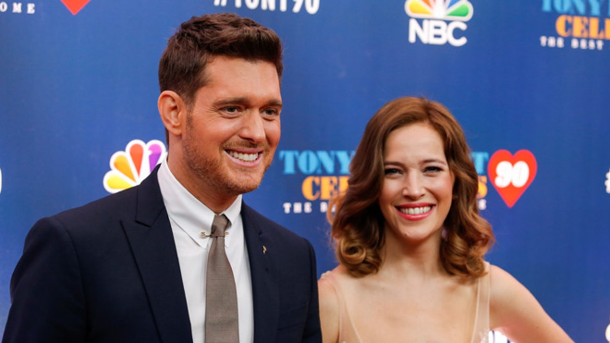 Singer Michael Buble (L) and Luisana Lopilato walk on the red carpet for 