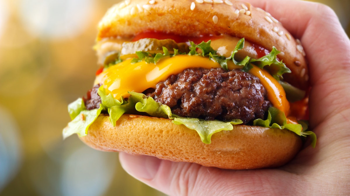 burger in hand istock medium