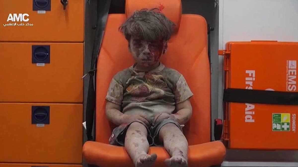 FILE --In this Aug. 17, 2016 file frame grab taken from video provided by the Syrian anti-government activist group Aleppo Media Center (AMC), 5-year-old Omran Daqneesh sits in an ambulance after being pulled out of a building hit by an airstrike in Aleppo, Syria. With its missile strike on Shayrat Airbase in central Syria, Washington signaled that it had judged President Bashar Assad responsible for the horrific chemical weapons attack in north Syria that drew international outrage last week. But it is not the first or even deadliest atrocity of the war.  (Aleppo Media Center via AP, File)