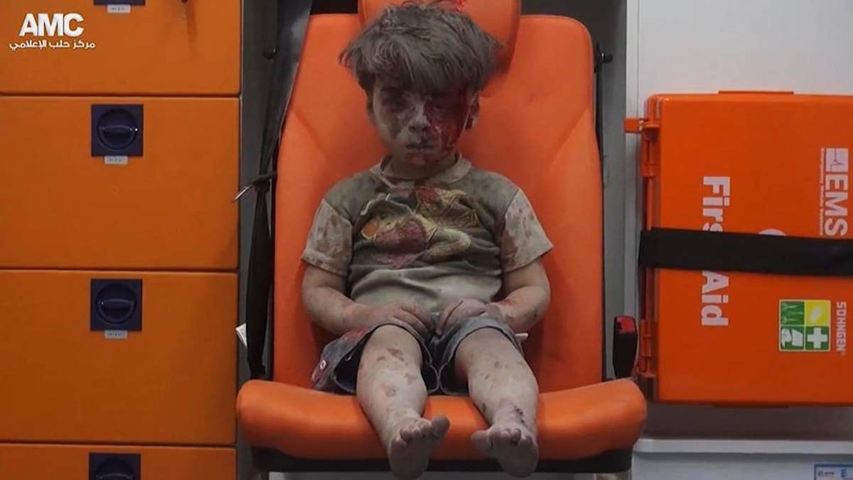 FILE --In this Aug. 17, 2016 file frame grab taken from video provided by the Syrian anti-government activist group Aleppo Media Center (AMC), 5-year-old Omran Daqneesh sits in an ambulance after being pulled out of a building hit by an airstrike in Aleppo, Syria. With its missile strike on Shayrat Airbase in central Syria, Washington signaled that it had judged President Bashar Assad responsible for the horrific chemical weapons attack in north Syria that drew international outrage last week. But it is not the first or even deadliest atrocity of the war.  (Aleppo Media Center via AP, File)