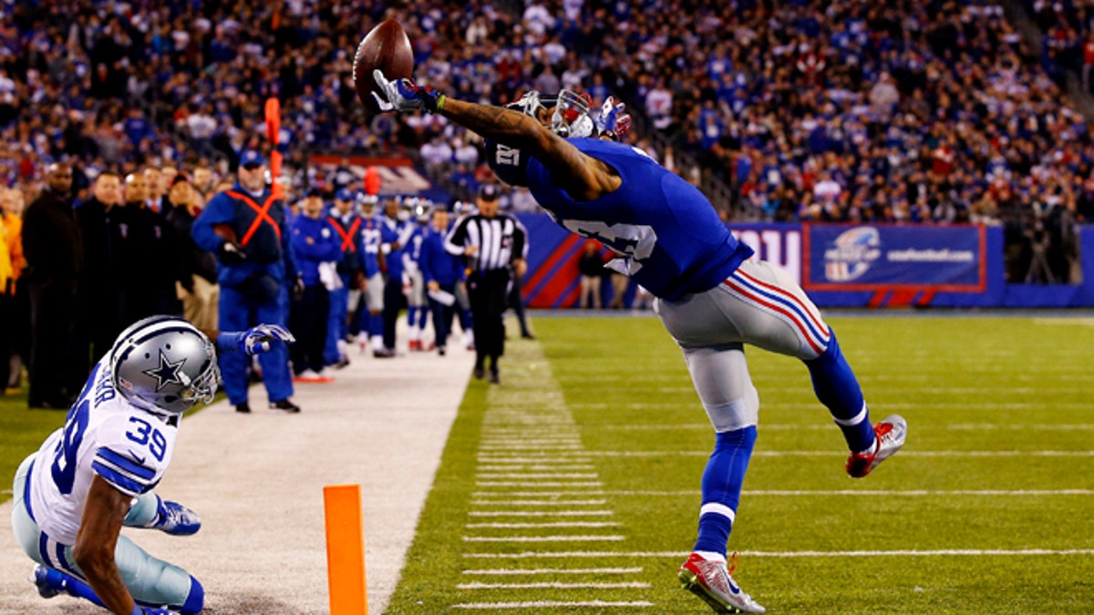 EAST RUTHERFORD, NJ - NOVEMBER 23:  Odell Beckham #13 of the New York Giants scores a touchdown in the second quarter against the Dallas Cowboys at MetLife Stadium on November 23, 2014 in East Rutherford, New Jersey.  (Photo by Al Bello/Getty Images)