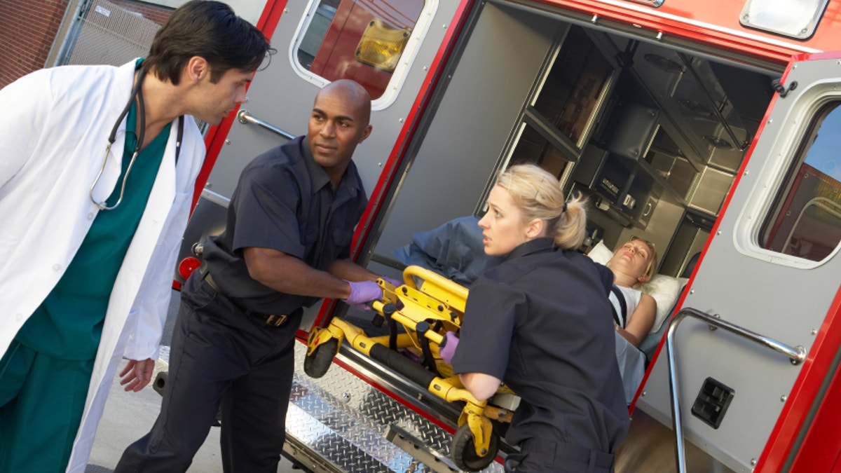 c656a219-Paramedics and doctor unloading patient from ambulance