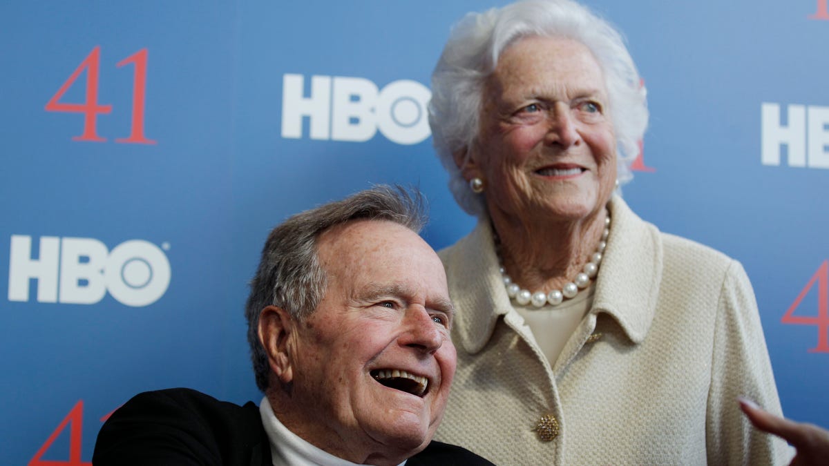 FILE - In a Tuesday, June 12, 2012 file photo, former President George H.W. Bush, and his wife, former first lady Barbara Bush, arrive for the premiere of HBO's new documentary on his life near the family compound in Kennebunkport, Maine. Bush spokesman Jim McGrath said Wednesday, Dec. 26. 2012 that doctors at the Houston hospital where Bush has been treated for a month remain “cautiously optimistic” that he will recover. Still, no discharge date has been set, and McGrath says that doctors are being cautious because at Bush’s age “sometimes issues crop up that are beyond anybody’s ability to discern or foretell.”(AP Photo/Charles Krupa, File) 