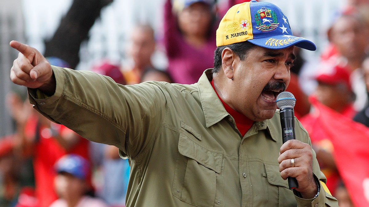 Venezuela's President Nicolas Maduro addresses supporters during a rally marking the anniversary of the 1992 failed coup led by late President Hugo Chavez in Caracas, Venezuela, Sunday, Feb. 4, 2018. Maduro will run for reelection in this year's presidential election. (AP Photo/Ariana Cubillos)