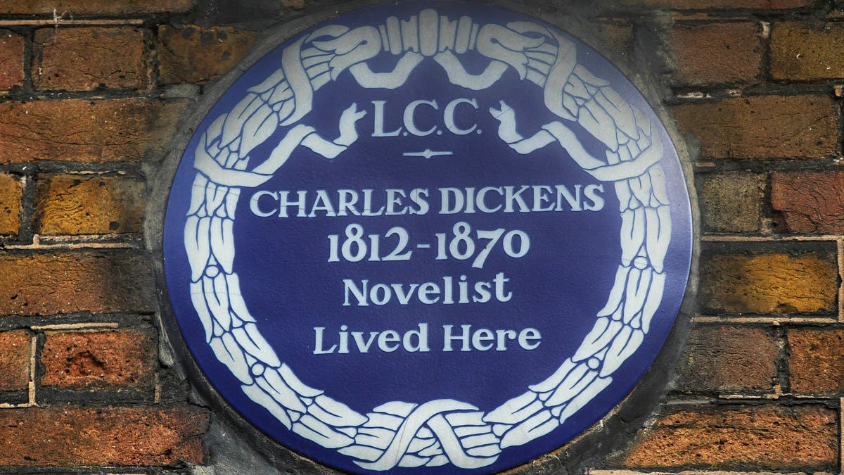 FILE - In this Dec. 5, 2012 file photo, a blue plaque is seen on the exterior of Charles Dickens' home, part of the Charles Dickens Museum in London. 
