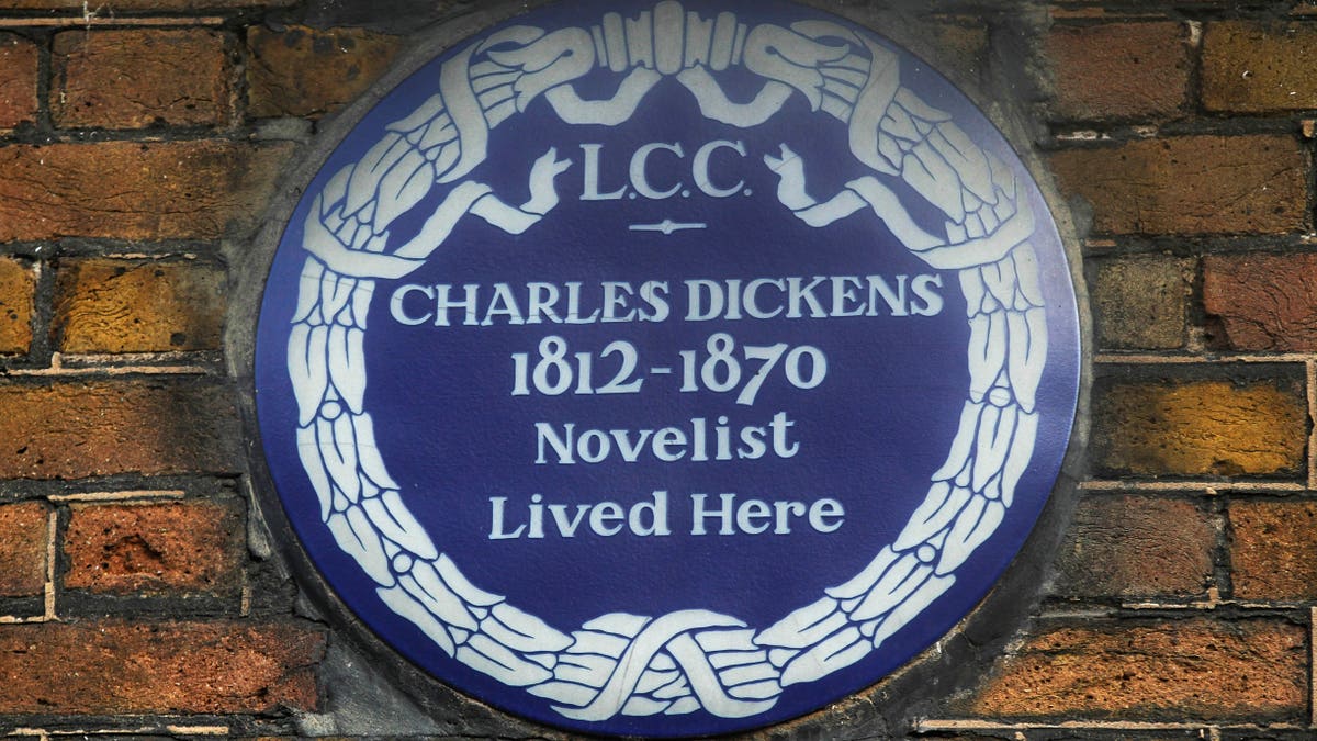 FILE - In this Dec. 5, 2012 file photo, a blue plaque is seen on the exterior of Charles Dickens' home, part of the Charles Dickens Museum in London. 