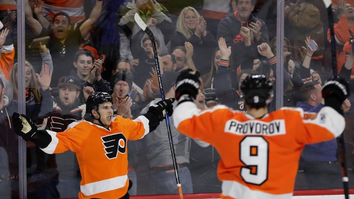 Philadelphia Flyers' Brayden Schenn, left, celebrates with Ivan Provorov after Schenn scored during overtime of an NHL hockey game against the Carolina Hurricanes, Sunday, March 19, 2017, in Philadelphia. Philadelphia won 4-3. (AP Photo/Matt Slocum)