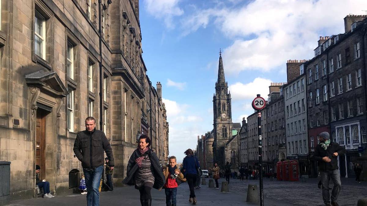 A family walks down a street in Edinburgh, Scotland, Tuesday, March 14, 2017. Scotland's leader delivered a shock twist to Britain's EU exit drama on Monday, announcing that she will seek authority to hold a new independence referendum in the next two years because Britain is dragging Scotland out of the EU against its will. First Minister Nicola Sturgeon said she would move quickly to give voters a new chance to leave the United Kingdom because Scotland was being forced into a "hard Brexit" that it didn't support. (AP Photo/Vitnija Saldava)