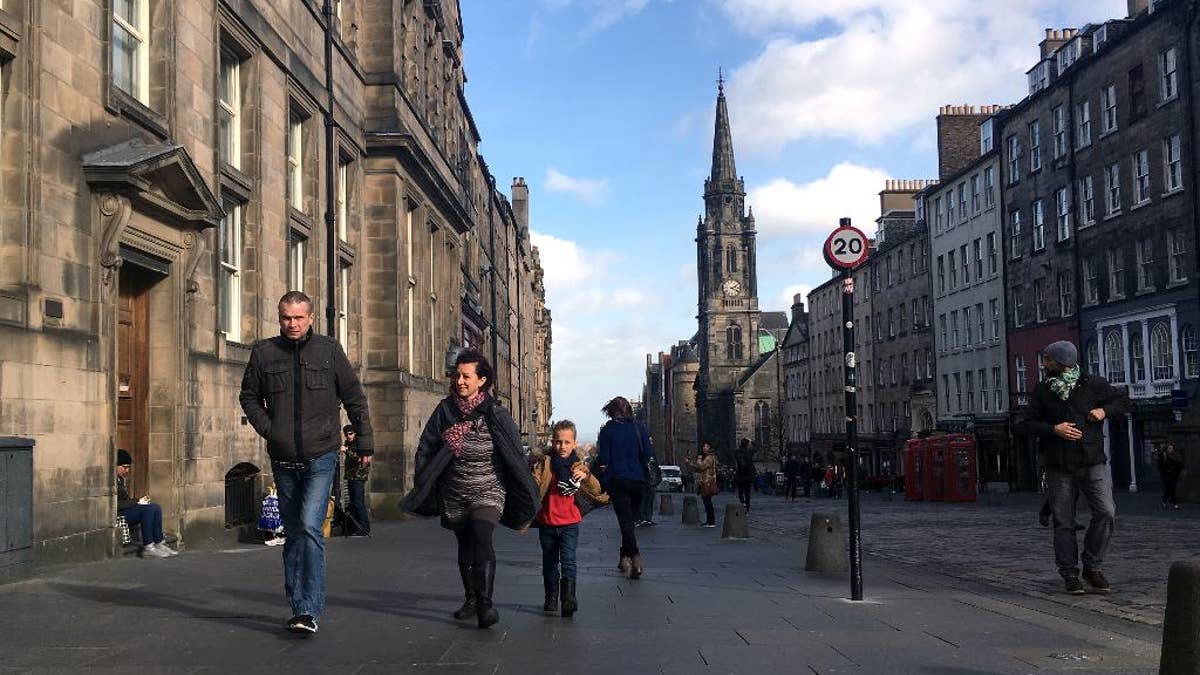 A family walks down a street in Edinburgh, Scotland, Tuesday, March 14, 2017. Scotland's leader delivered a shock twist to Britain's EU exit drama on Monday, announcing that she will seek authority to hold a new independence referendum in the next two years because Britain is dragging Scotland out of the EU against its will. First Minister Nicola Sturgeon said she would move quickly to give voters a new chance to leave the United Kingdom because Scotland was being forced into a "hard Brexit" that it didn't support. (AP Photo/Vitnija Saldava)