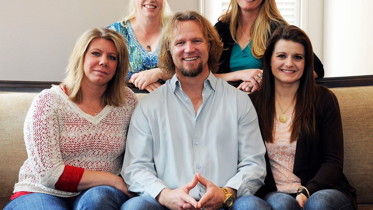 FILE - In this July 10, 2013, file photo, Kody Brown poses with his wives at one of their homes in Las Vegas. Utah's attorney general has filed notice that he will appeal a ruling striking down parts of the state's anti-polygamy law in a lawsuit brought by the family on the TLC reality TV show "Sister Wives." Attorney General Sean Reyes filed the notice Wednesday, about a month after a federal judge issued a final ruling in the case. (AP Photo/Las Vegas Review-Journal, Jerry Henkel, File)