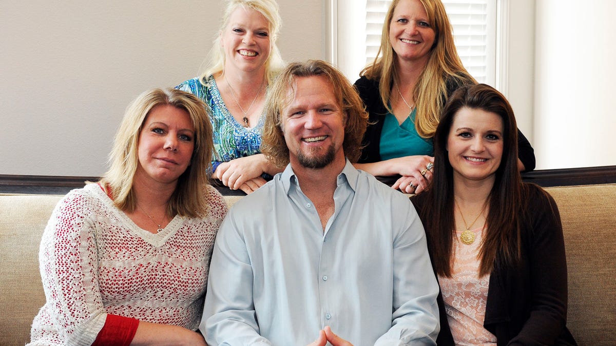 FILE - In this July 10, 2013, file photo, Kody Brown poses with his wives at one of their homes in Las Vegas. Utah's attorney general has filed notice that he will appeal a ruling striking down parts of the state's anti-polygamy law in a lawsuit brought by the family on the TLC reality TV show 