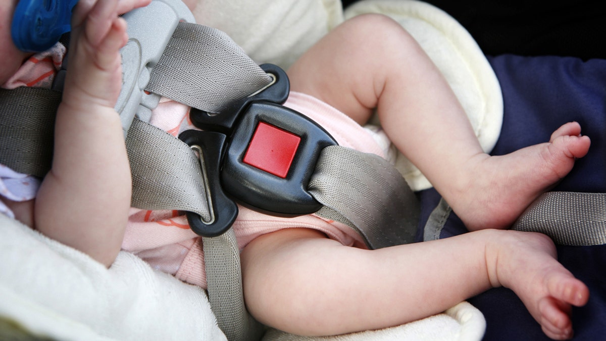 Baby in car-seat bucked up