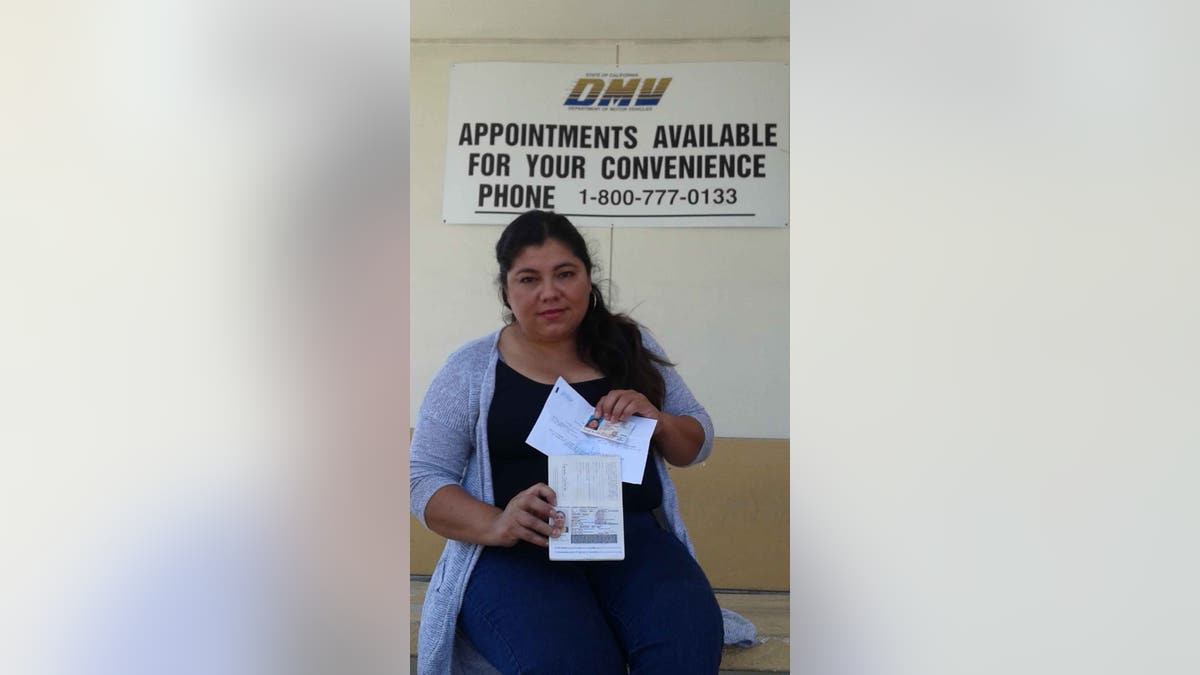 Carmela Gonzalez shows her new driver's license.