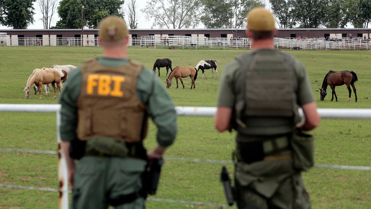 FBI agents looking at horses