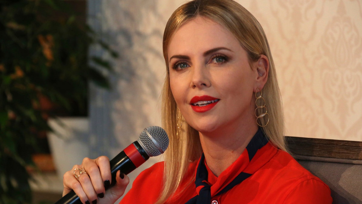 Actress Charlize Theron speaks at an event at the Global Education and Skills Forum in Dubai, United Arab Emirates, Saturday, March 17, 2018. Theron said Saturday that the idea of arming teachers after recent U.S. school shootings or otherwise "adding more guns" to the situation is "so outrageous." (AP Photo/Jon Gambrell)