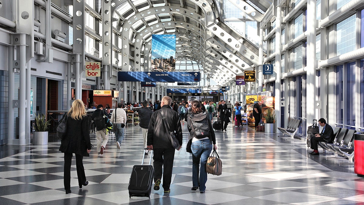 Chicago, United States - April 1, 2014: Travelers walk to gates at Chicago O'Hare International Airport in USA. It was the 5th busiest airport in the world with 66,883,271 passengers in 2013.