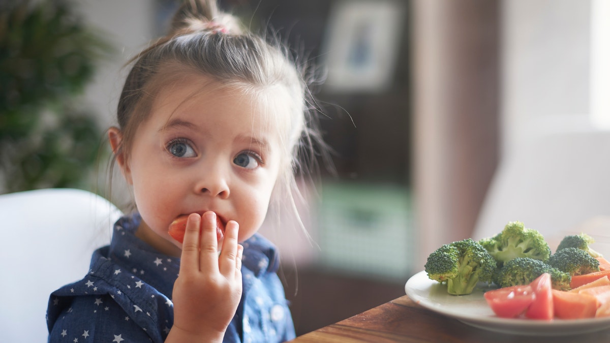 child eating veggies istock