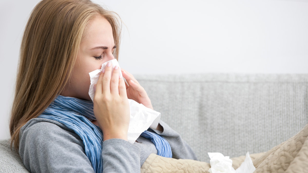 common cold flu sick woman stay home from work istock