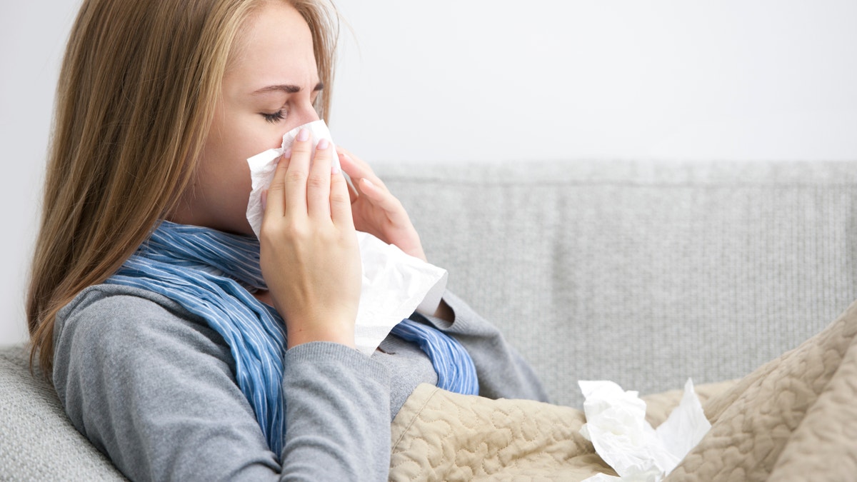 common cold flu sick woman stay home from work istock