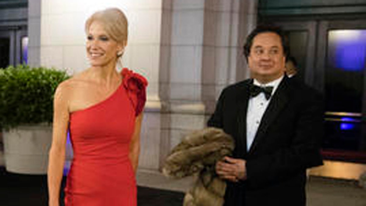 FILE - In this Thursday, Jan. 19, 2017 file photo, President-elect Donald Trump adviser Kellyanne Conway, center, accompanied by her husband, George, speaks with members of the media as they arrive for a dinner at Union Station in Washington, the day before Trump's inauguration. Trump has chosen George Conway to head the civil division of the Justice Department. The Wall Street Journal reports that he was chosen to head the office that has responsibility for defending the administration's proposed travel ban and defending lawsuits filed against the administration. The White House and the Justice Department would not confirm the pick Saturday, March 18, 2017. George Conway declined to comment. (AP Photo/Matt Rourke)