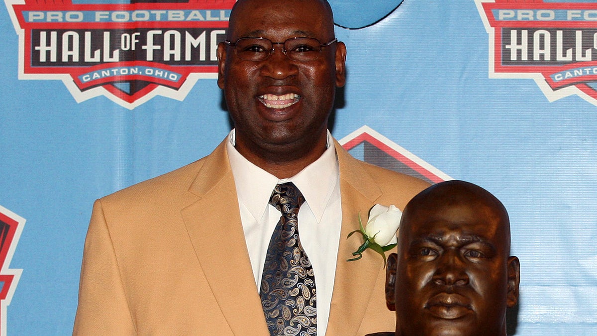 Former Seattle Seahawk Cortez Kennedy stands with his bust after being accepted  into the Pro Football Hall of Fame in Canton, Ohio August 4, 2012. REUTERS/Aaron Josefczyk (UNITED STATES - Tags: SPORT FOOTBALL) - RTR365XF