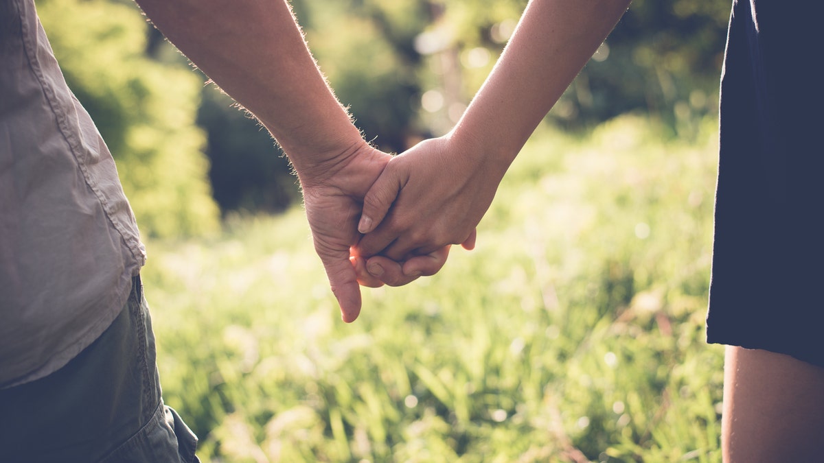 couple holding hands istock medium