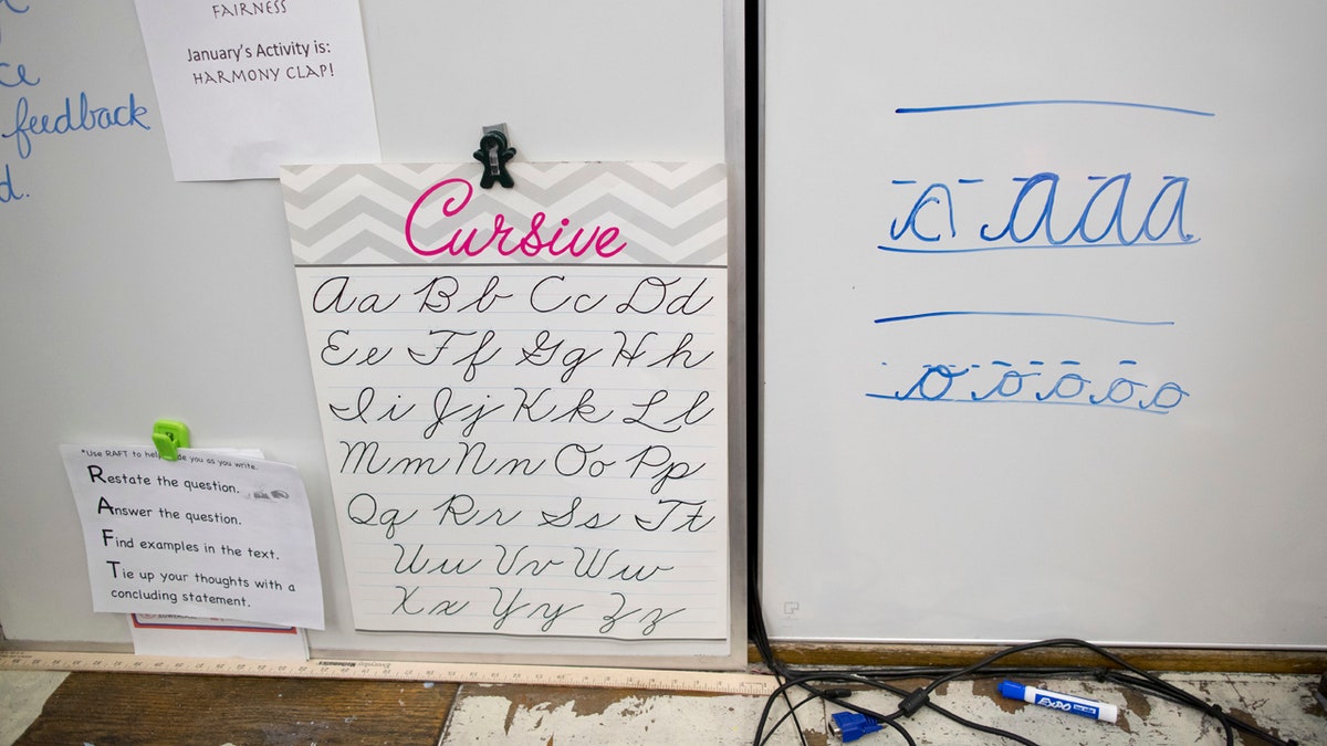 In this Wednesday, March 1, 2017, photo, a sample of cursive letters are on display in the third-grade classroom at P.S. 166 in the Queens borough of New York. Schools Chancellor Carmen Farina distributed a handbook on teaching cursive writing in September and is encouraging principals to use it. (AP Photo/Mary Altaffer)
