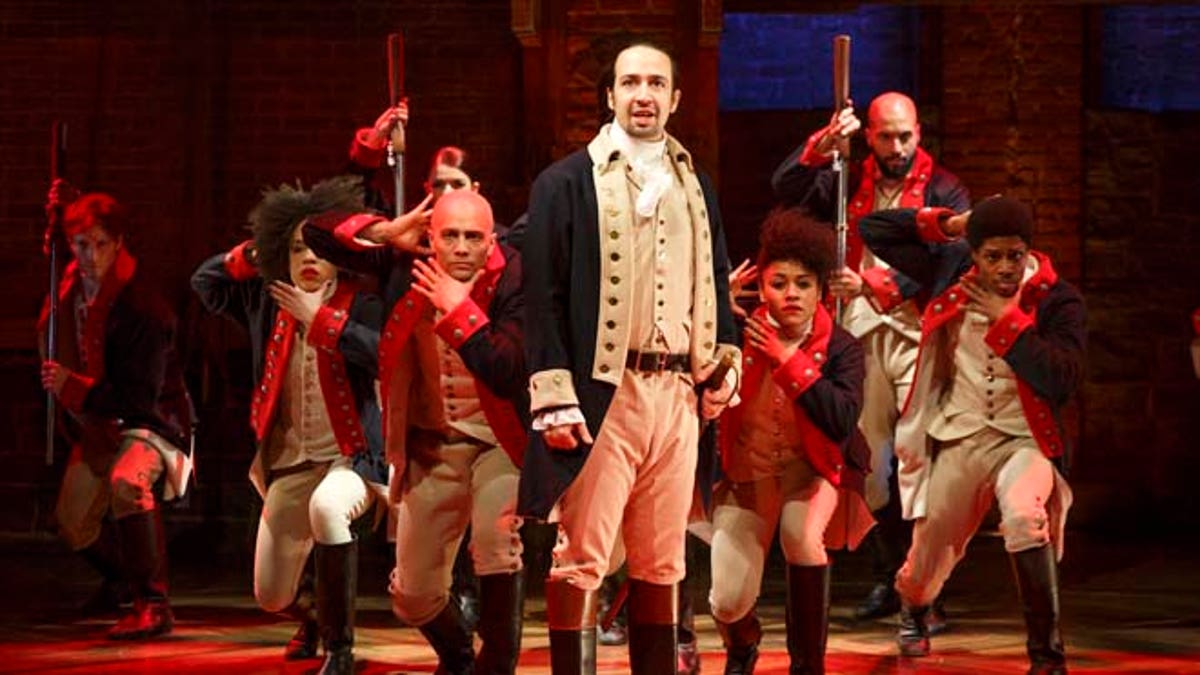 This image released by The Public Theater shows Lin-Manuel Miranda, foreground, with the cast during a performance of 