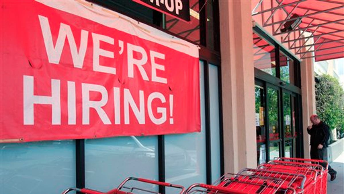 In this April 25, 2011 photo, a "We're Hiring!" sign is shown at Office Depot in Mountain View, Calif. More people sought unemployment benefits last week, the second rise in three weeks, a sign the job market's recovery is slow and uneven.(AP Photo/Paul Sakuma)