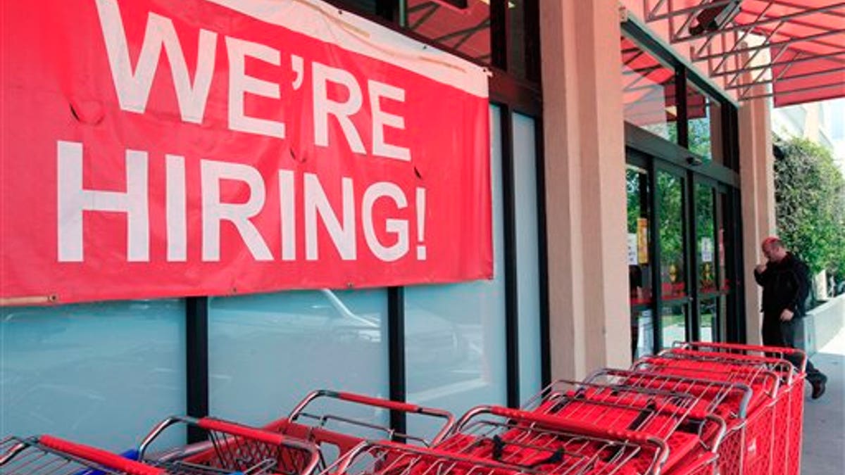 In this April 25, 2011 photo, a "We're Hiring!" sign is shown at Office Depot in Mountain View, Calif. More people sought unemployment benefits last week, the second rise in three weeks, a sign the job market's recovery is slow and uneven.(AP Photo/Paul Sakuma)