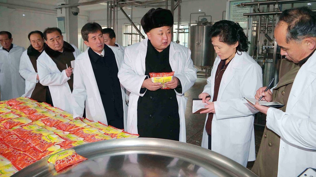 North Korean leader Kim Jong Un gives field guidance to the Pyongyang Children's Foodstuff Factory in this undated photo released by North Korea's Korean Central News Agency (KCNA) in Pyongyang December 16, 2014. REUTERS/KCNA (NORTH KOREA - Tags: POLITICS) ATTENTION EDITORS - THIS PICTURE WAS PROVIDED BY A THIRD PARTY. REUTERS IS UNABLE TO INDEPENDENTLY VERIFY THE AUTHENTICITY, CONTENT, LOCATION OR DATE OF THIS IMAGE. FOR EDITORIAL USE ONLY. NOT FOR SALE FOR MARKETING OR ADVERTISING CAMPAIGNS. THIS PICTURE IS DISTRIBUTED EXACTLY AS RECEIVED BY REUTERS, AS A SERVICE TO CLIENTS. NO THIRD PARTY SALES. NOT FOR USE BY REUTERS THIRD PARTY DISTRIBUTORS. SOUTH KOREA OUT. NO COMMERCIAL OR EDITORIAL SALES IN SOUTH KOREA - GM1EACG1JVR01