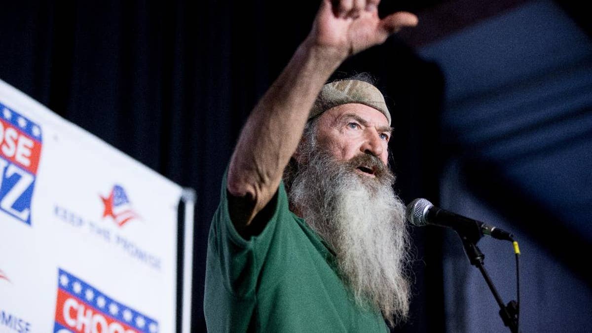 FILE - In this Feb. 19, 2016 file photo, Phil Robertson of the Duck Dynasty reality television program speaks at a rally for Republican presidential candidate, Sen. Ted Cruz, R-Texas, at Eagle Aviation Hangar in Columbia, S.C. Robertson has again clouded NASCAR's image as a sport trying to remove itself from its divisive stereotypes. Robertson called for a 