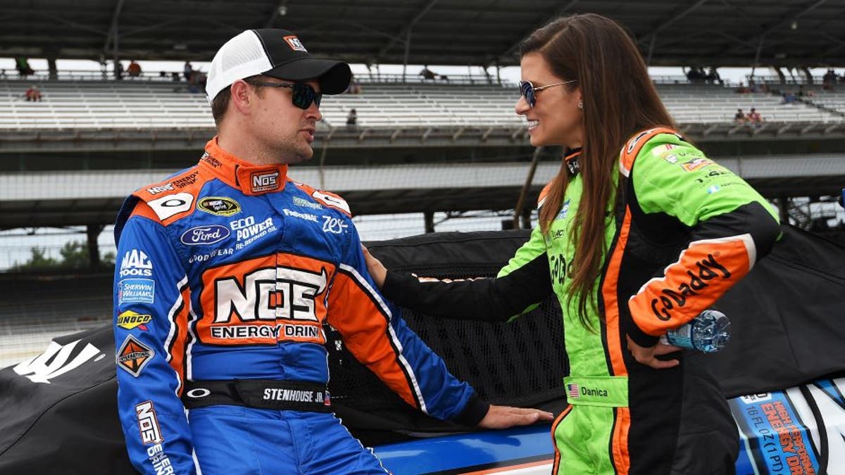 INDIANAPOLIS, IN - JULY 25: Ricky Stenhouse Jr., driver of the #17 NOS Energy Drink Ford, talks with Danica Patrick, driver of the #10 GoDaddy Chevrolet, during qualifying for the NASCAR Sprint Cup Series Crown Royal Presents the Jeff Kyle 400 at the Brickyard at Indianapolis Motor Speedway on July 25, 2015 in Indianapolis, Indiana. (Photo by Rainier Ehrhardt/NASCAR via Getty Images)