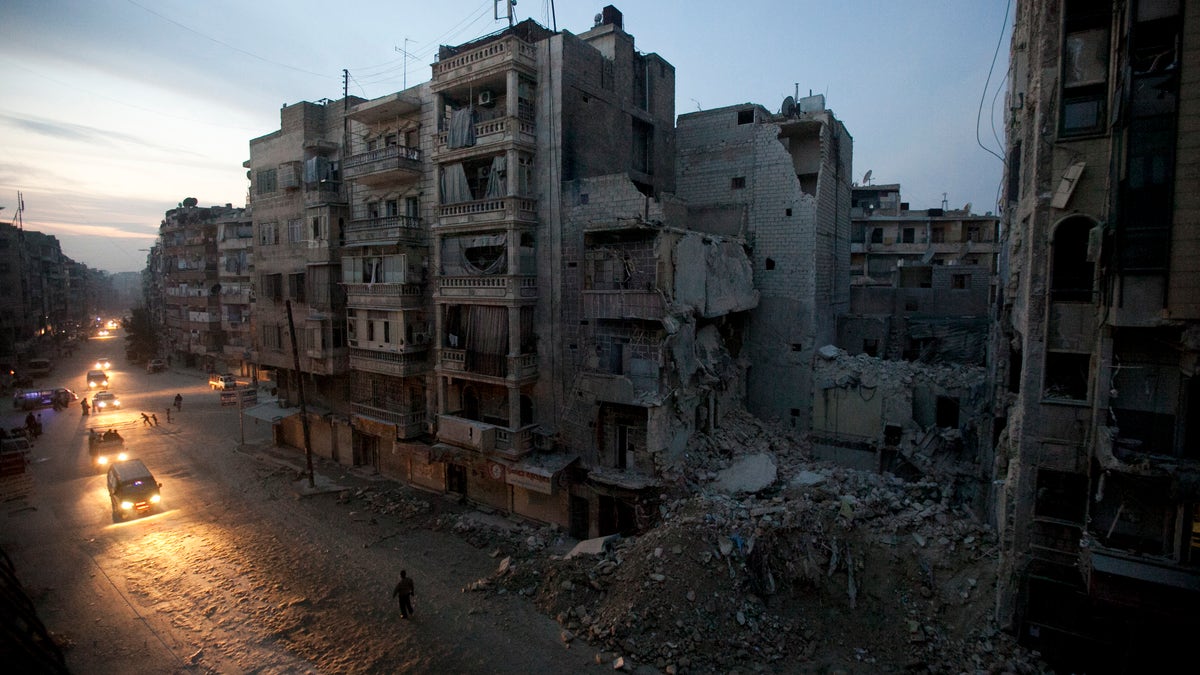 Nov. 29, 2012: Night falls on a Syrian rebel-controlled area of Aleppo as destroyed buildings, including Dar Al-Shifa hospital, are seen on Sa'ar street after airstrikes targeted the area a week before. 