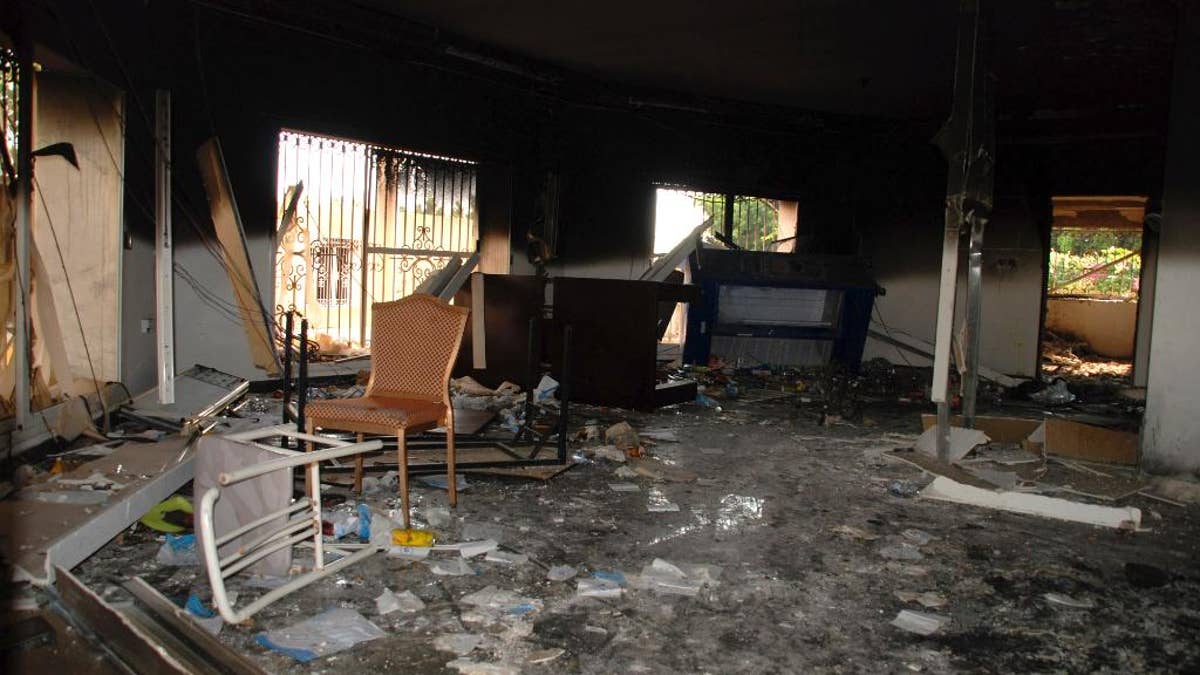 FILE - In this Sept. 12, 2012 file photo, glass, debris and overturned furniture are strewn inside a room in the gutted U.S. consulate in Benghazi, Libya, after an attack that killed four Americans, including Ambassador Chris Stevens. Democrats on the House Benghazi panel said in a report Monday, June 27, 2016, that security at the Libya facility the night of Sept. 11, 2012 was “woefully inadequate,” but former Secretary of State Hillary Clinton never personally denied any requests from diplomats for additional protection.  (AP Photo/Ibrahim Alaguri, File)