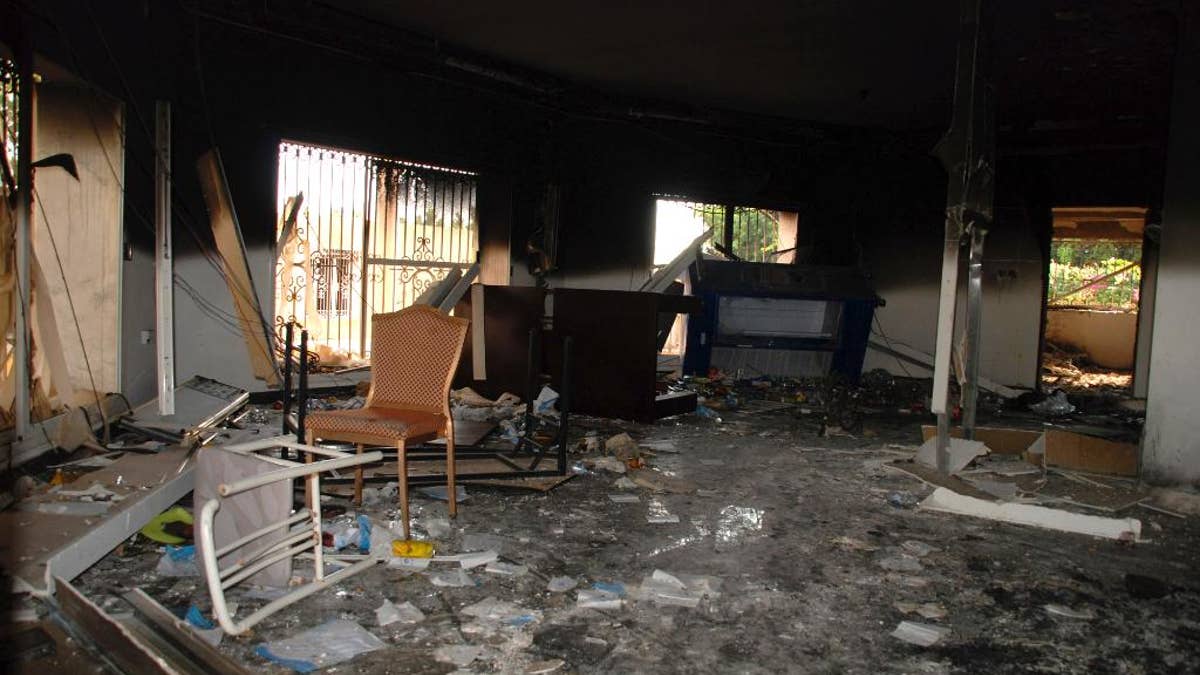 FILE - In this Sept. 12, 2012 file photo, glass, debris and overturned furniture are strewn inside a room in the gutted U.S. consulate in Benghazi, Libya, after an attack that killed four Americans, including Ambassador Chris Stevens. Democrats on the House Benghazi panel said in a report Monday, June 27, 2016, that security at the Libya facility the night of Sept. 11, 2012 was “woefully inadequate,” but former Secretary of State Hillary Clinton never personally denied any requests from diplomats for additional protection. (AP Photo/Ibrahim Alaguri, File)