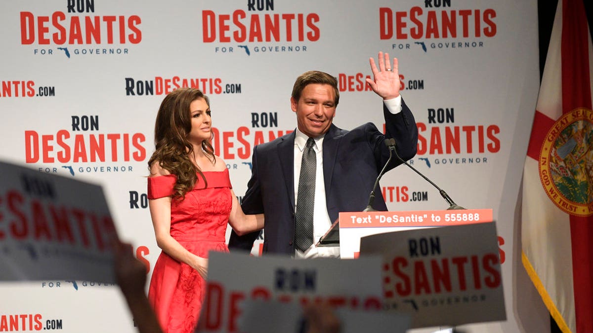 Florida Republican gubernatorial candidate Ron DeSantis, right, waves to supporters with his wife, Casey, at an election party after winning the Republican primary, Tuesday, Aug. 28, 2018, in Orlando, Fla. (AP Photo/Phelan M. Ebenhack)