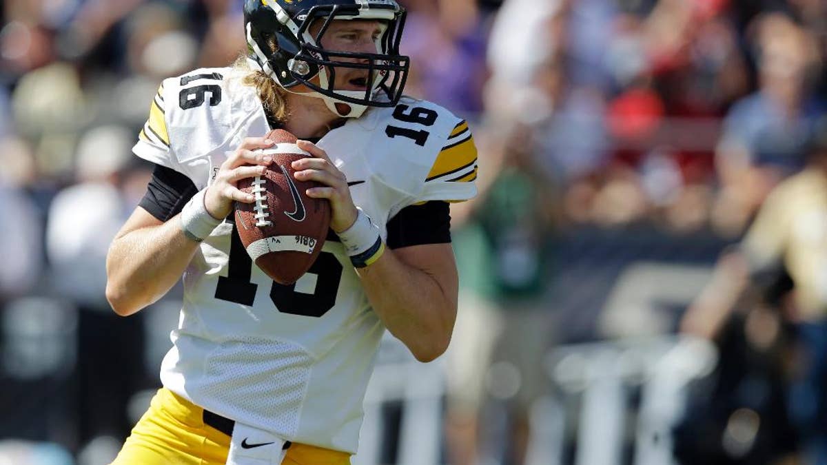 Iowa quarterback C.J. Beathard  drops back to throw against Purdue during the first half of an NCAA college football game in West Lafayette, Ind., Saturday, Sept. 27, 2014. (AP Photo/Michael Conroy)