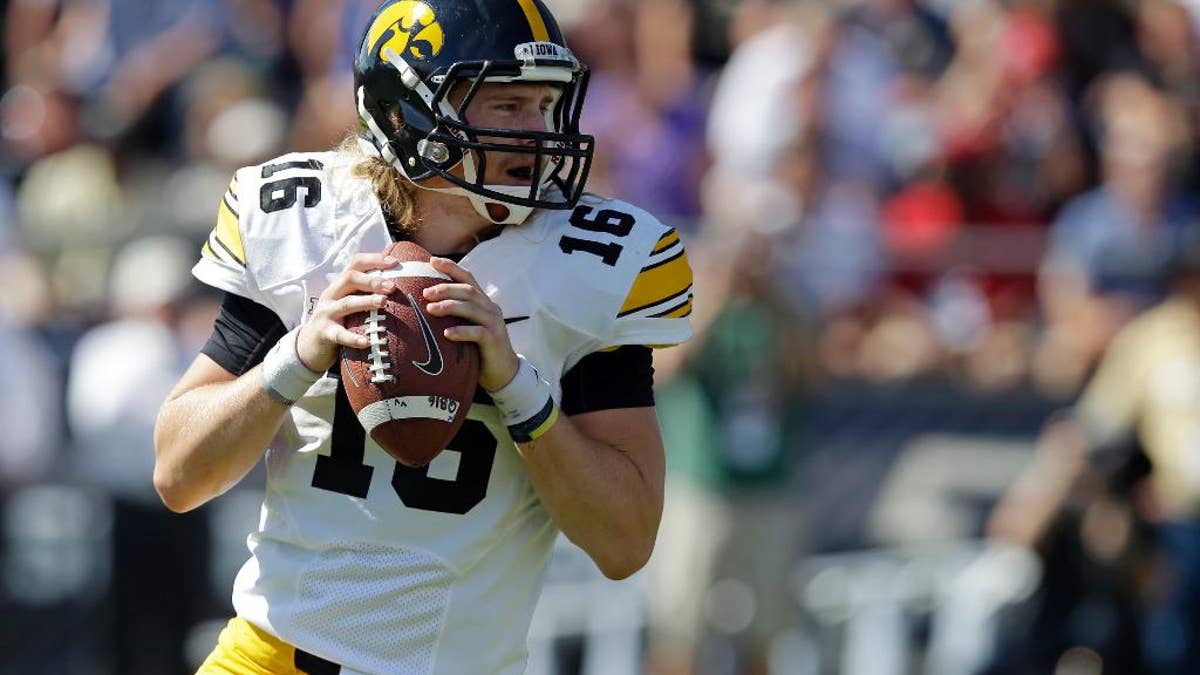 Iowa quarterback C.J. Beathard  drops back to throw against Purdue during the first half of an NCAA college football game in West Lafayette, Ind., Saturday, Sept. 27, 2014. (AP Photo/Michael Conroy)