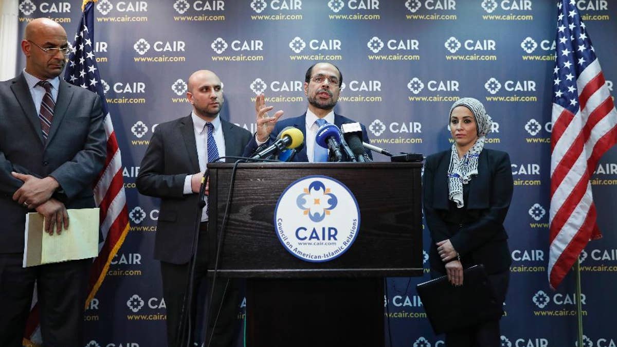 Attorneys Shereef Akeel, left, Gadeir Abbas, and Lena F. Masri, right, stand as Council on American-Islamic Relations (CAIR) national executive director Nihad Awad speaks during a news conference at the Council on American-Islamic Relations (CAIR), Monday, Jan. 30, 2017 in Washington. The group announced the filing of a federal lawsuit on behalf of more than 20 individuals challenging an executive order signed by President Donald Trump. (AP Photo/Alex Brandon)