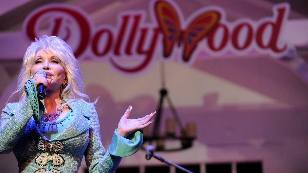 FILE - In this Aug. 21, 2013, file photo, Dolly Parton speaks during a news conference to announce plans to expand her Dollywood properties in Pigeon Forge, Tenn. Parton's Dollywood amusement park has announced a $37 million expansion with rides, a restaurant and live entertainment. (AP Photo/Amy Smotherman Burgess, Knoxville News Sentinel, File)