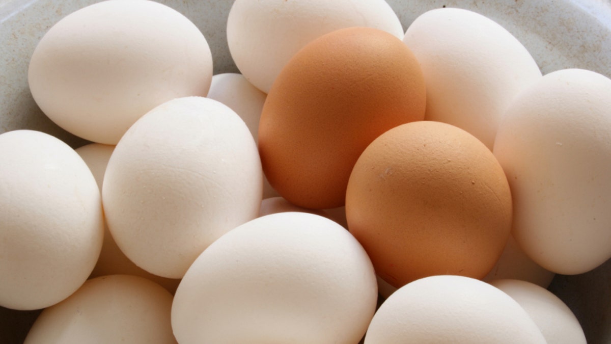 A lot of white and brown chicken eggs close-up