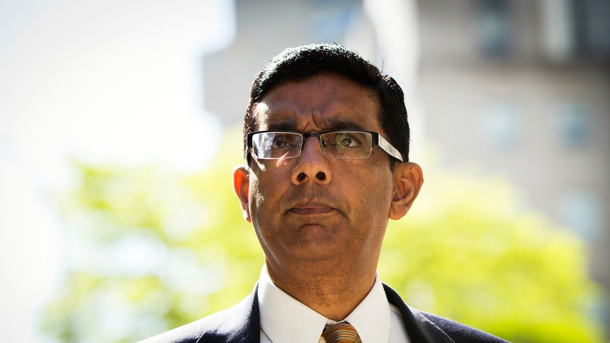 Conservative commentator and best-selling author, Dinesh D'Souza exits the Manhattan Federal Courthouse after pleading guilty in New York, May 20, 2014. D'Souza pleaded guilty to one criminal count of making illegal contributions in the names of others. A second count concerning the making of false statements is expected to be dismissed once the defendant is sentenced. REUTERS/Lucas Jackson (UNITED STATES - Tags: CRIME LAW BUSINESS) - RTR3Q10M