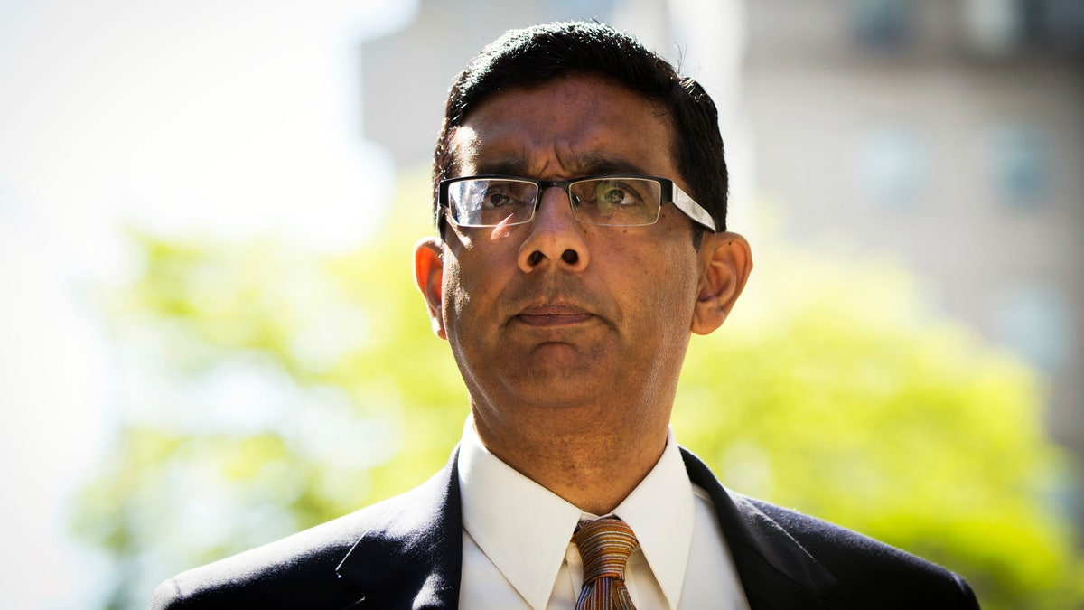 Conservative commentator and best-selling author, Dinesh D'Souza exits the Manhattan Federal Courthouse after pleading guilty in New York, May 20, 2014. D'Souza pleaded guilty to one criminal count of making illegal contributions in the names of others. A second count concerning the making of false statements is expected to be dismissed once the defendant is sentenced. REUTERS/Lucas Jackson (UNITED STATES - Tags: CRIME LAW BUSINESS) - RTR3Q10M